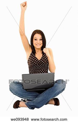 Beautiful caucasian woman sitting on a white background working on laptop computer View Large Photo Image Stock Photo - Beautiful caucasian woman sitting on a white background working on laptop computer. Fotosearch