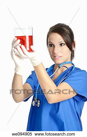 Beautiful Caucasian woman working as a laboratory technician studing a beaker of red liquid View Large Photo Image Stock Photography - Beautiful Caucasian woman working as a laboratory technician studing a beaker of red liquid. Fotosearch