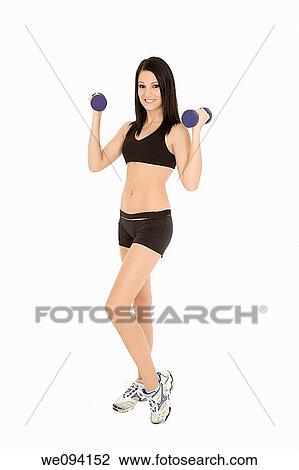 Beautiful Caucasian woman working out with dumbbells on white background View Large Photo Image Stock Image - Beautiful Caucasian woman working out with dumbbells on white background. Fotosearch