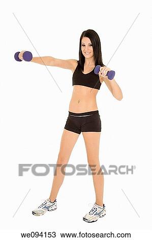 Stock Image - Beautiful Caucasian woman working out with dumbbells on white background. Fotosearch