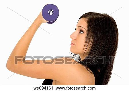 Stock Image - Beautiful Caucasian woman working out with dumbbells on white background. Fotosearch