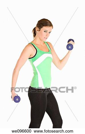Stock Image - Beautiful Caucasian woman working out with dumbbells. Fotosearch