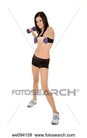 Stock Photo - Beautiful Caucasian woman working out with dumbbells on white background. Fotosearch