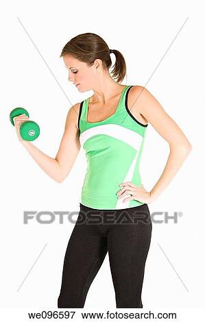 Beautiful Caucasian woman working out with dumbbells View Large Photo Image Stock Photo - Beautiful Caucasian woman working out with dumbbells. Fotosearch