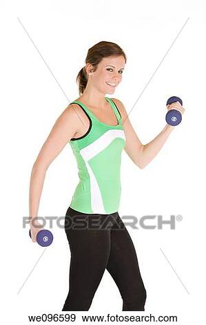 Beautiful Caucasian woman working out with dumbbells View Large Photo Image Stock Photo - Beautiful Caucasian woman working out with dumbbells. Fotosearch