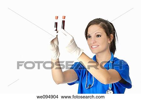 Beautiful laboratory technician examining a tube of blood View Large Photo Image Picture - Beautiful laboratory technician examining a tube of blood. Fotosearch