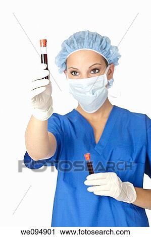 Beautiful laboratory technician examining a tube of blood View Large Photo Image Stock Image - Beautiful laboratory technician examining a tube of blood. Fotosearch