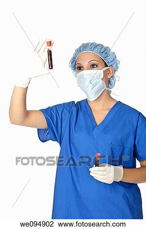 Beautiful laboratory technician examining a tube of blood View Large Photo Image Stock Image - Beautiful laboratory technician examining a tube of blood. Fotosearch