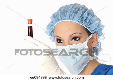 Beautiful laboratory technician examining a tube of blood View Large Photo Image Stock Photo - Beautiful laboratory technician examining a tube of blood. Fotosearch
