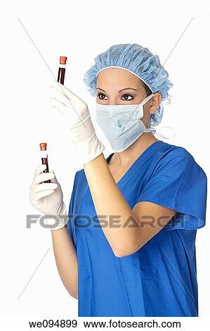 Beautiful laboratory technician examining a tube of blood View Large Photo Image Stock Photo - Beautiful laboratory technician examining a tube of blood. Fotosearch