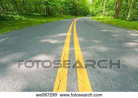 Beautiful scenic country road curves through Great Smoky Mountain National Park View Large Photo Image Stock Photo - Beautiful scenic country road curves through Great Smoky Mountain National Park. Fotosearch