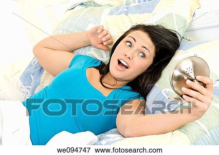 Stock Photo - Beautiful woman over sleeping in the morning. Fotosearch