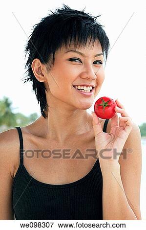 Beautiful young asian woman looking at camera View Large Photo Image Stock Photo - Beautiful young asian woman looking at camera. Fotosearch