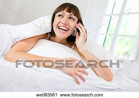 bed, calling, brunette, bedroom, at-home View Large Photo Image Stock Image - bed, calling, brunette, bedroom, at-home. Fotosearch
