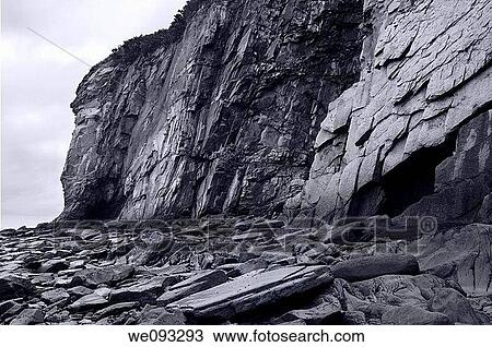 Black and white image of sheer rock cliff face at Cape Enrage New Brunswick View Large Photo Image Stock Image - Black and white image of sheer rock cliff face at Cape Enrage New Brunswick. Fotosearch