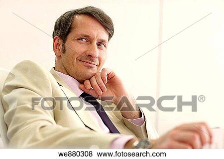 Stock Photo - black hair, blue eyes, business, businessman, businesspeople. Fotosearch