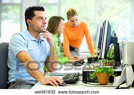 Stock Image - black hair, cell phone, business, absorbed. Fotosearch