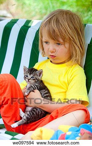 blond boy playing with kitten View Large Photo Image Picture - blond boy playing with kitten. Fotosearch