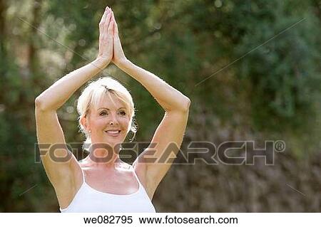 Stock Photography - blond, contemporary, Arms raised. Fotosearch