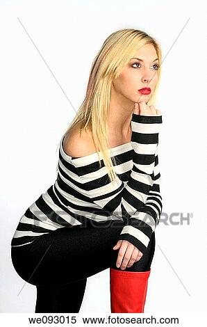 Blond woman hand on chin with leg up and red boots in a black and white sweater on white background View Large Photo Image Stock Photography - Blond woman hand on chin with leg up and red boots in a black and white sweater on white background. Fotosearch