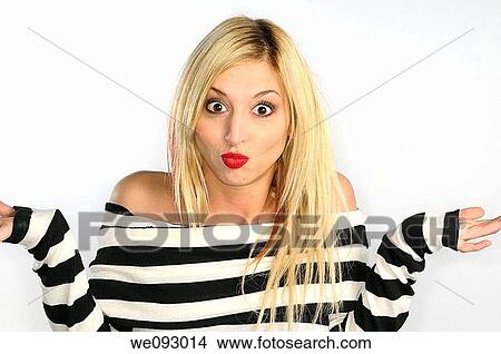 Blond woman with bare shoulders pouting and shrugging in a black and white sweater on white background View Large Photo Image Picture - Blond woman with bare shoulders pouting and shrugging in a black and white sweater on white background. Fotosearch