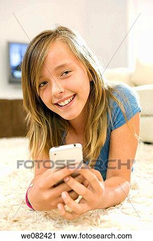 blue eyes, cell phone, carpet, brown hair, at-home View Large Photo Image Stock Image - blue eyes, cell phone, carpet, brown hair, at-home. Fotosearch