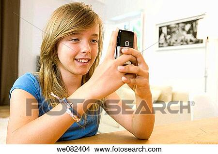 blue eyes, chestnut hair, cell phone, brown hair, at-home View Large Photo Image Picture - blue eyes, chestnut hair, cell phone, brown hair, at-home. Fotosearch