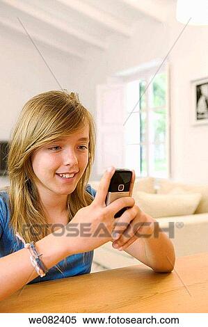 blue eyes, chestnut hair, cell phone, brown hair, at-home View Large Photo Image Stock Photography - blue eyes, chestnut hair, cell phone, brown hair, at-home. Fotosearch