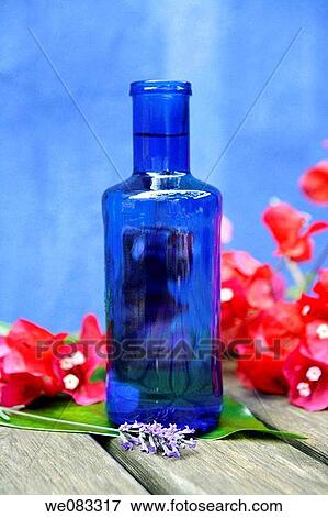 blue glass bottle, lavender flowers ans bouganvillea over wood View Large Photo Image Stock Photo - blue glass bottle, lavender flowers ans bouganvillea over wood. Fotosearch