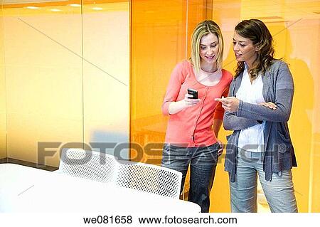 Stock Photo - board-room, business, cell phone, colleague. Fotosearch