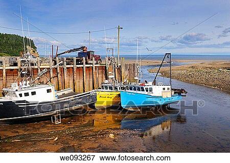 Boats moored at the Alma wharf at sundown low tide on the Bay of Fundy New Brunswick View Large Photo Image Stock Photo - Boats moored at the Alma wharf at sundown low tide on the Bay of Fundy New Brunswick. Fotosearch