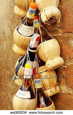 Bottles of Chianti Montelonti Le Coste hanging in front of the local wine shop in Italy View Large Photo Image Picture - Bottles of Chianti Montelonti Le Coste hanging in front of the local wine shop in Italy. Fotosearch