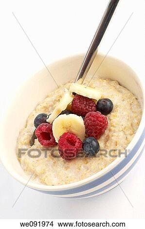 Picture - Bowl of Porridge with raspberries, blueberries and banana. Fotosearch