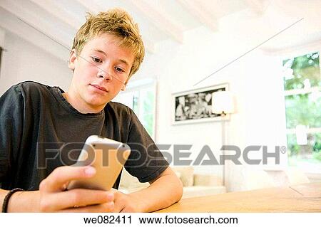 Stock Image - boy, child, cell phone, at-home. Fotosearch