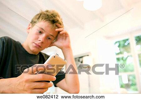 Stock Image - boy, child, cell phone, at-home. Fotosearch