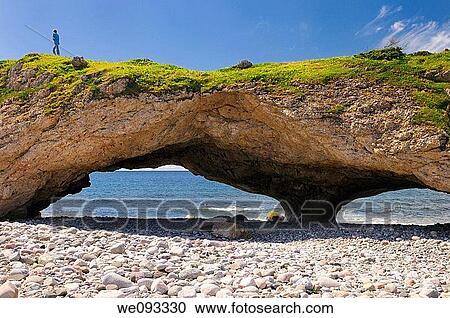 Boy walking on the roof of an arch at Arches Provincial Park Newfoundland Canada View Large Photo Image Stock Image - Boy walking on the roof of an arch at Arches Provincial Park Newfoundland Canada. Fotosearch