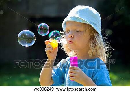 boy with long blond hair blowing soap bubbles outdoors View Large Photo Image Stock Photo - boy with long blond hair blowing soap bubbles outdoors. Fotosearch