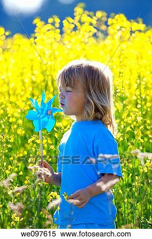 boy with long blond hair holding pinwheel in canola field View Large Photo Image Stock Photography - boy with long blond hair holding pinwheel in canola field. Fotosearch