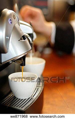 Brewing coffee in espresso machine View Large Photo Image Stock Photo - Brewing coffee in espresso machine. Fotosearch