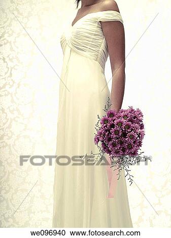 Bride in a white wedding dress holding a flower bouquet View Large Photo Image Stock Image - Bride in a white wedding dress holding a flower bouquet. Fotosearch