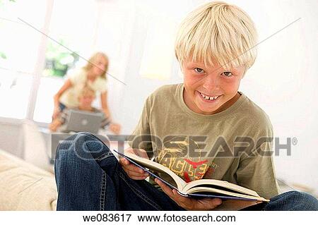 Stock Photo - brother, blond, boy, book, blue eyes, at-home. Fotosearch