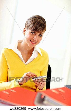 Stock Photo - business, businesspeople, businesswoman, cell phone. Fotosearch