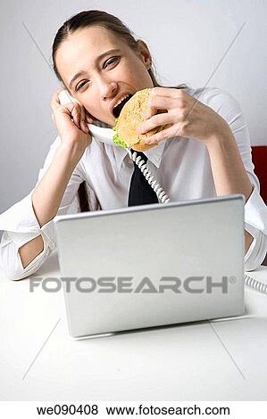 Business Woman Eating Sandwich and Working View Large Photo Image Stock Photo - Business Woman Eating Sandwich and Working. Fotosearch