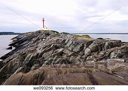Cape Forchu peninsula and lighthouse with wet rocks at Yarmouth Harbour Nova Scotia View Large Photo Image Stock Photograph - Cape Forchu peninsula and lighthouse with wet rocks at Yarmouth Harbour Nova Scotia. Fotosearch