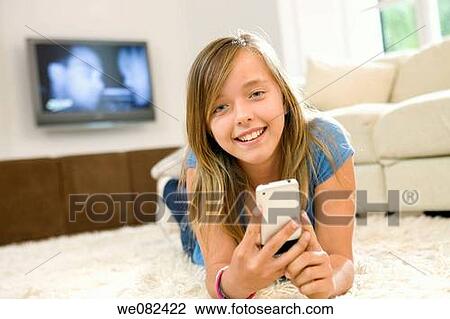 carpet, child, cell phone, at-home View Large Photo Image Stock Image - carpet, child, cell phone, at-home. Fotosearch