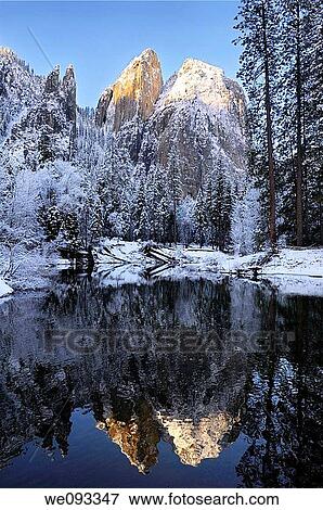 Cathedral Rocks and Spires reflected in the Merced River after a snowfall in winter View Large Photo Image Stock Photo - Cathedral Rocks and Spires reflected in the Merced River after a snowfall in winter. Fotosearch