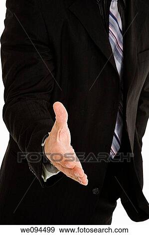 Caucasian businessman holding out hand to greet someone View Large Photo Image Stock Photo - Caucasian businessman holding out hand to greet someone. Fotosearch