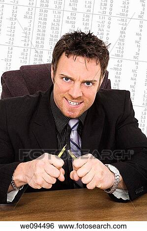Caucasian businessman setting at a desk and looking very angry and frustrated because of the Stock Market View Large Photo Image Stock Photograph - Caucasian businessman setting at a desk and looking very angry and frustrated because of the Stock Market. Fotosearch