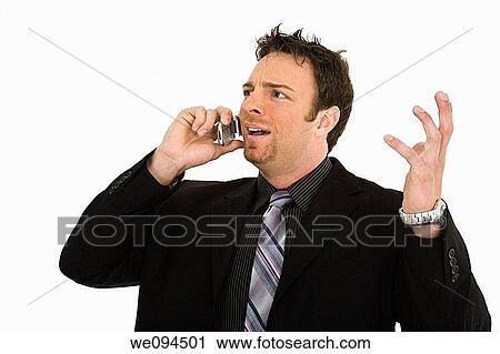 Caucasian businessman standing and talking on the cell phone and angry View Large Photo Image Stock Image - Caucasian businessman standing and talking on the cell phone and angry. Fotosearch