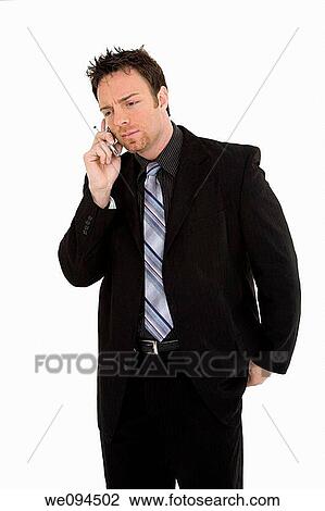 Caucasian businessman standing and talking on the cell phone View Large Photo Image Stock Image - Caucasian businessman standing and talking on the cell phone. Fotosearch